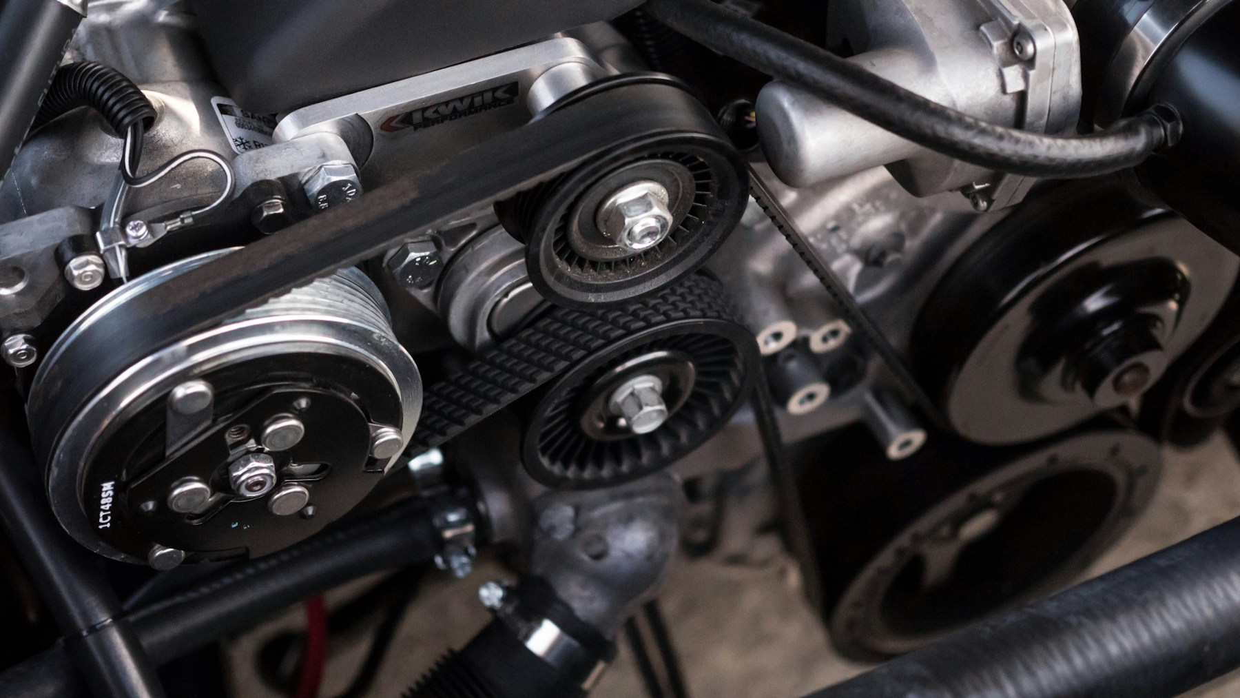 Close-up of engine components and drive belts